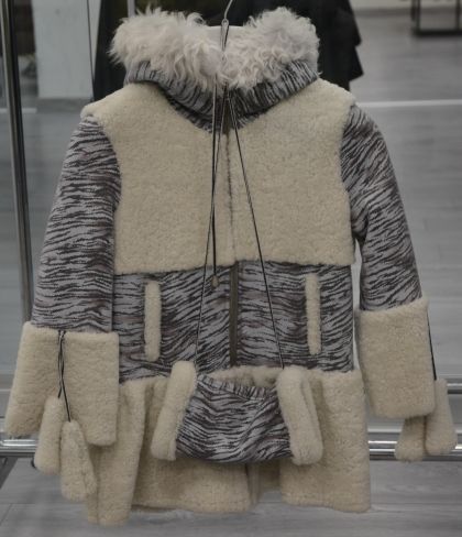 Children's coat for a girl with a cuff